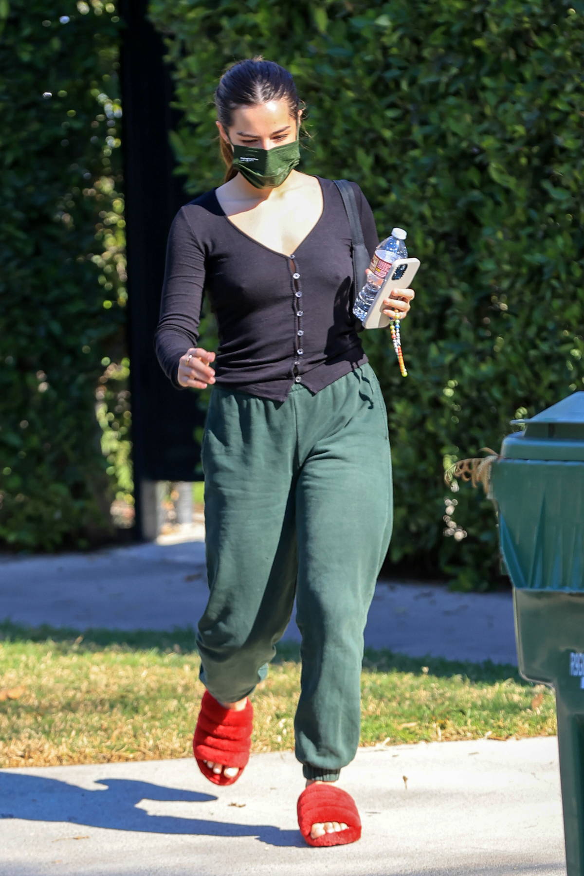 addison rae looks comfy in a black top, green sweatpants and red