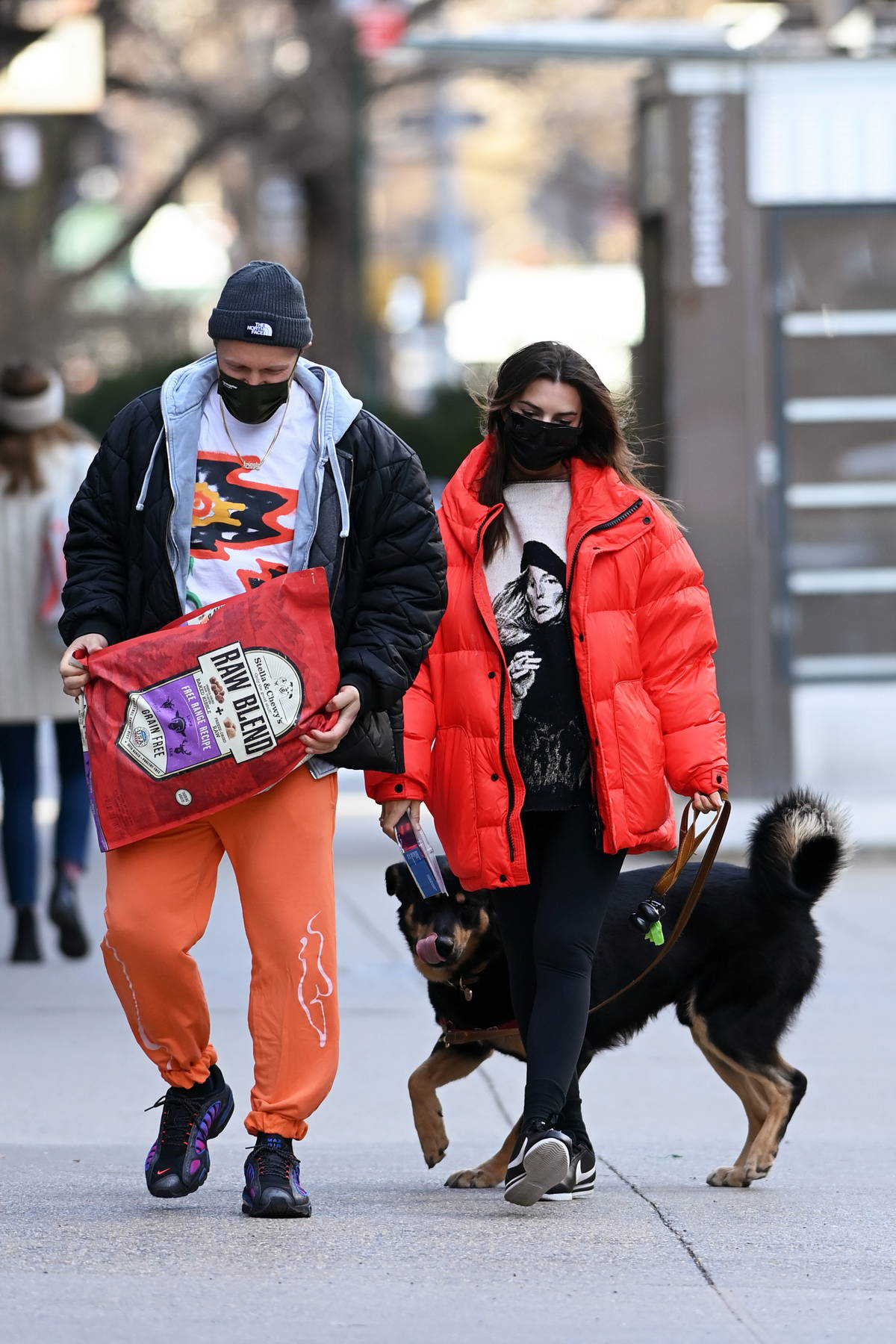 emily ratajkowski wears a red puffer jacket and black leggings as she steps  out to walk her dog in new york city-280121_7