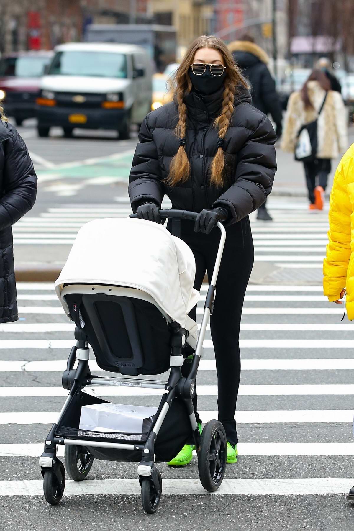 Gigi Hadid sports a black puffer jacket and leggings while out with her  baby daughter in