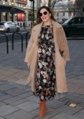 Kelly Brook looks lovely in a tan coat over a floral print dress as she arrives at Heart radio in London, UK