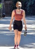 Lucy Hale shows off her fit figure in a maroon crop and black lycra shorts during a hiking session in Los Angeles