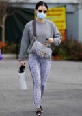 Lucy Hale sports a grey sweatshirt and animal print leggings as she heads for a workout in Los Angeles