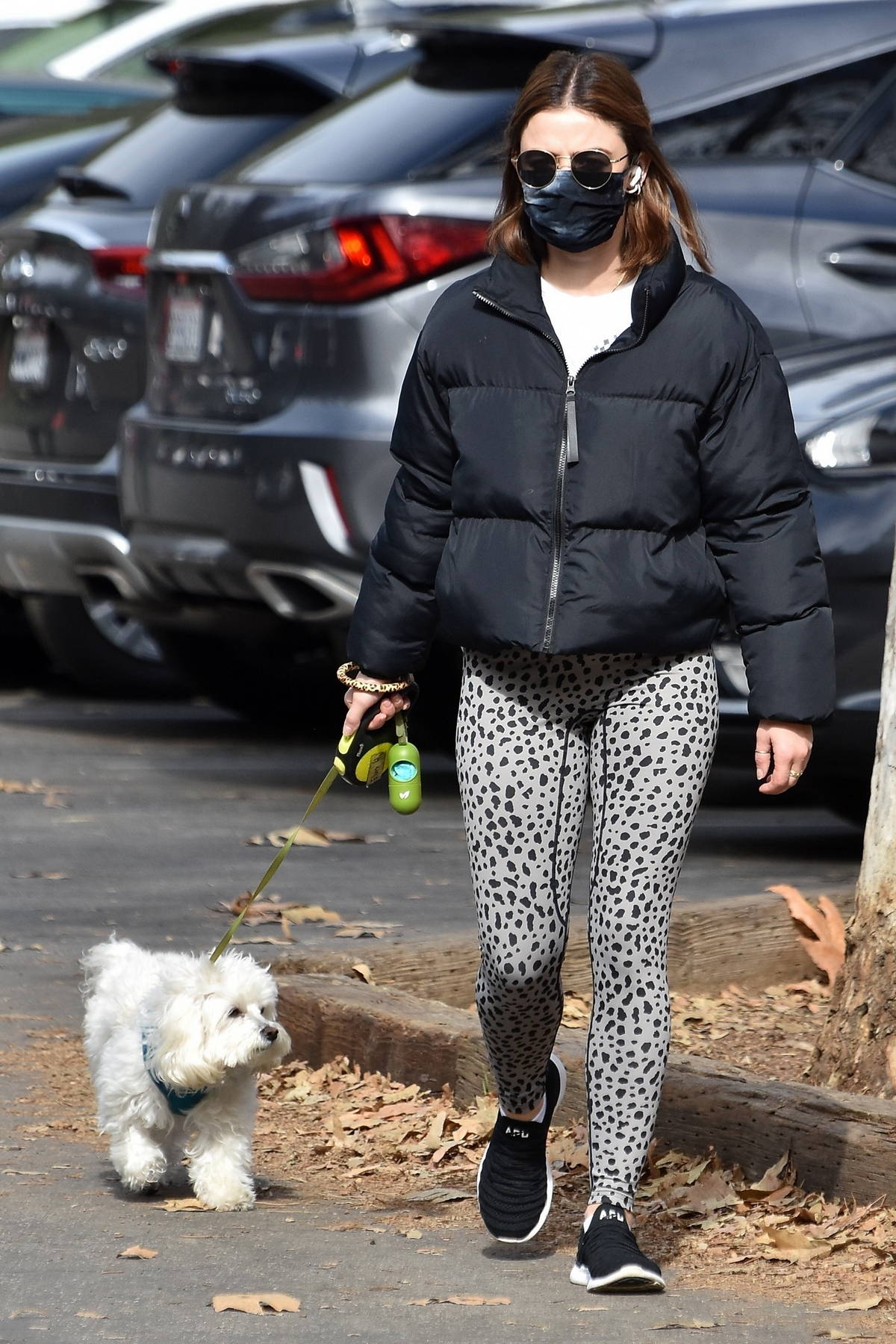 Lucy Hale wears black puffer jacket and animal print leggings while out for  a hike with