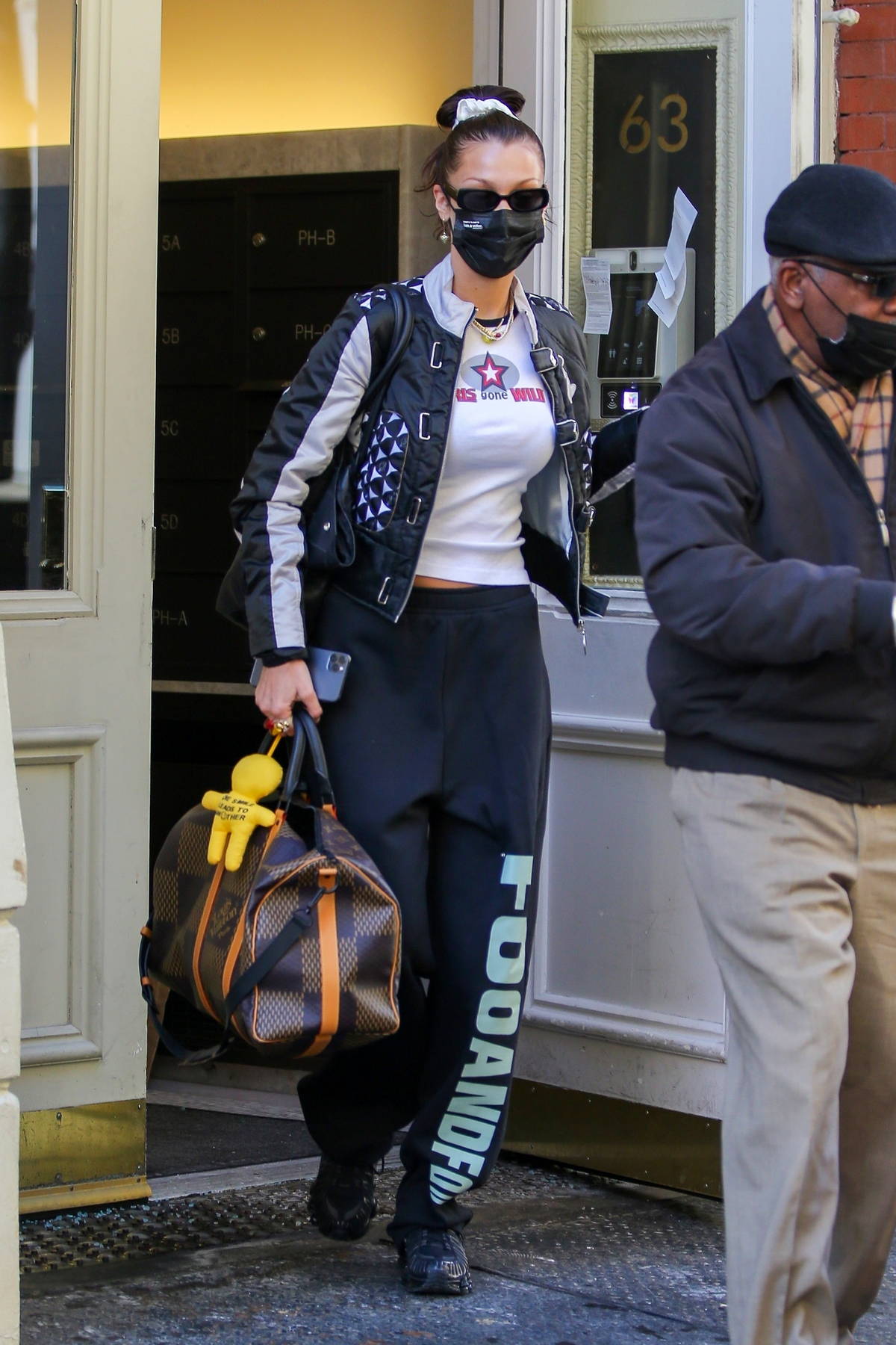 Bella Hadid carries her Louis Vuitton and Chanel bags as she steps