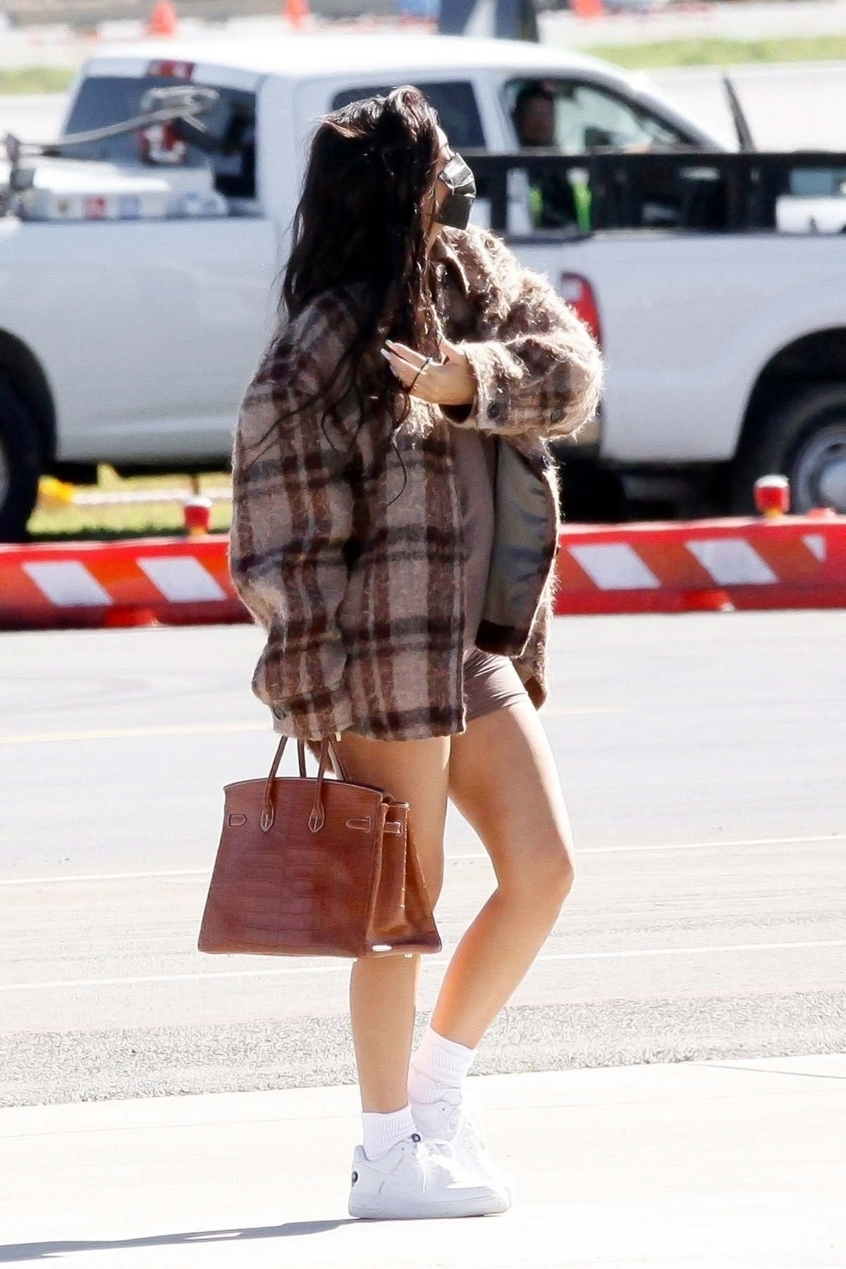 Kylie Jenner Puts On A Leggy Display While Boarding A Private Jet With Her Daughter Stormi In