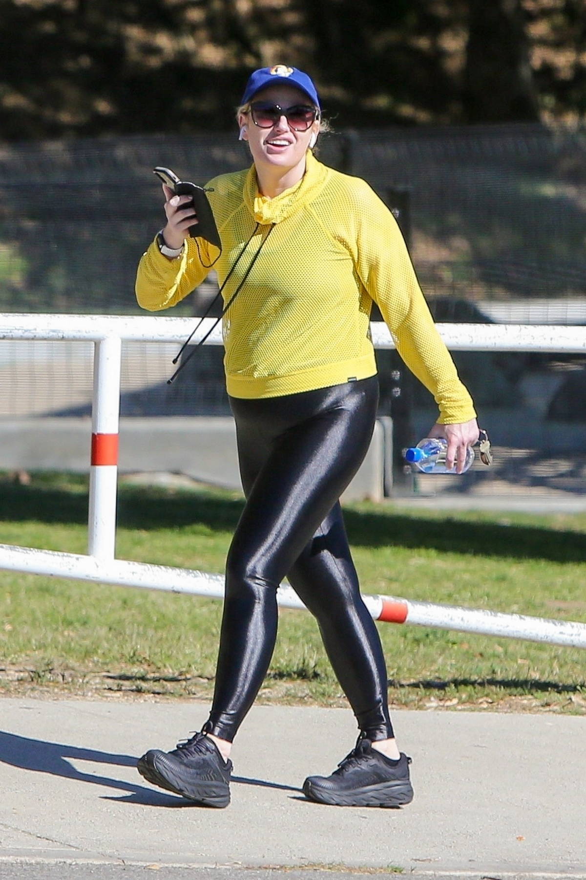 https://www.celebsfirst.com/wp-content/uploads/2021/02/rebel-wilson-stands-out-in-bright-yellow-hoodie-and-black-leggings-while-out-for-hike-in-los-feliz-california-230221_1.jpg