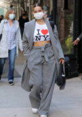 Addison Rae flashes her toned abs in a cropped 'I Love NY' tee paired with a grey suit as she leaves her Hotel in New York City