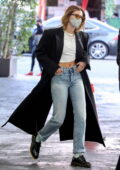 Hailey Bieber looks trendy in a full-length coat over a crop top while out running errands in Beverly Hills, California