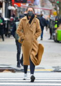 Katie Holmes bundles up in full-length coat over a hoodie and leggings while out for a stroll in New York City