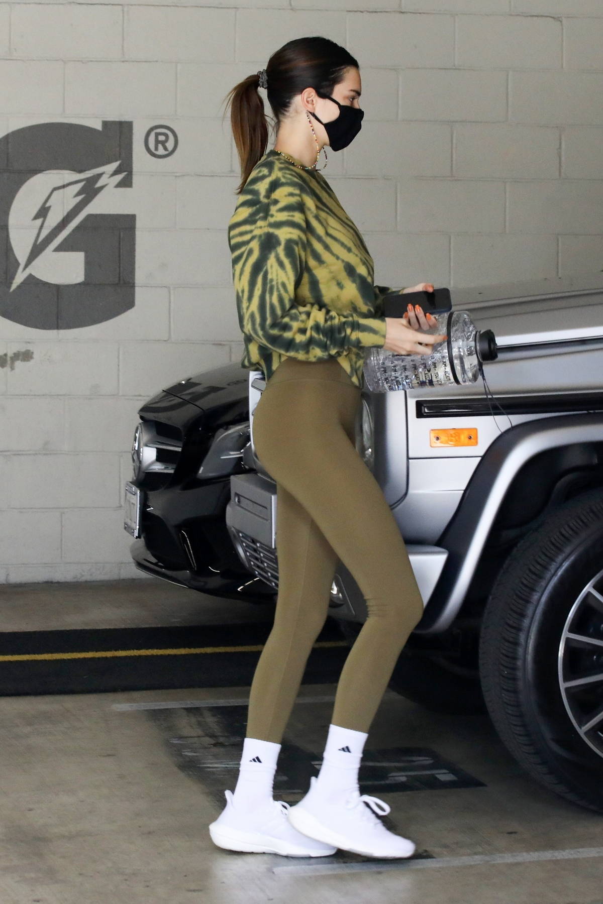 Kendall Jenner displays her model figure in green leggings while