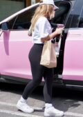 addison rae flaunts her curves in black leggings while grabbing a