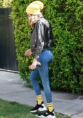 Cara Delevingne rocks a black leather jacket and blue leggings as she  leaves a Pilates class