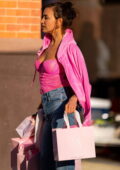 Irina Shayk poses in a hot pink corset top and jeans during a Victoria's  Secret photoshoot