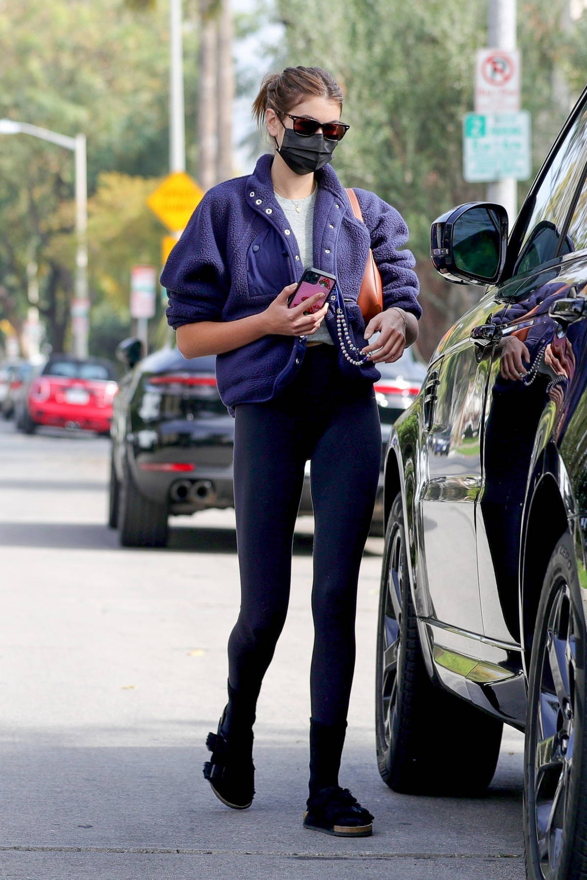 Victoria Justice shows off her toned figure in a sports bra and legging  shorts during a