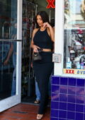 Kim Kardashian makes a stop at an adult store before boarding a private jet to fly out of Miami, Florida