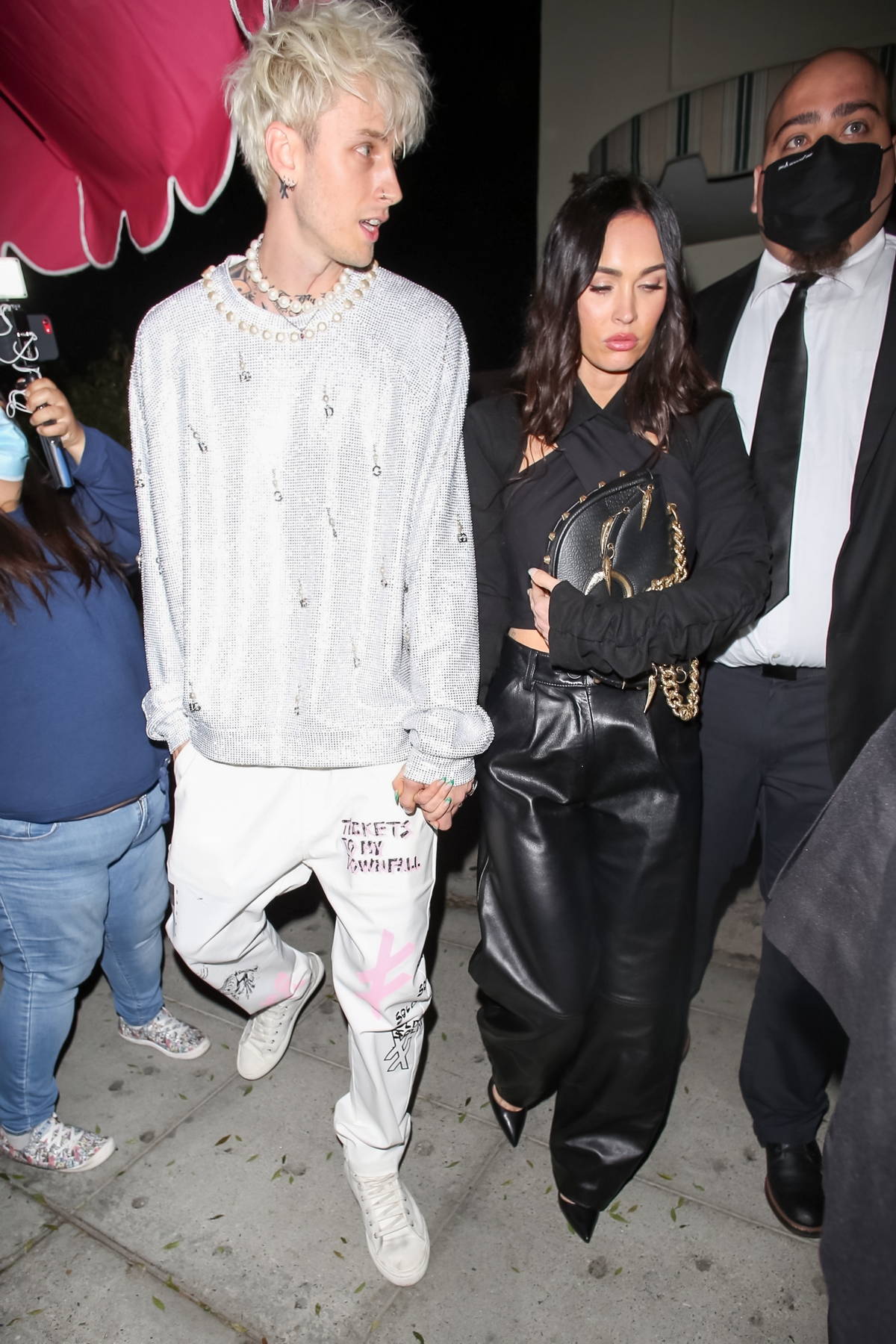 megan fox and machine gun kelly hold hands as they leave after a