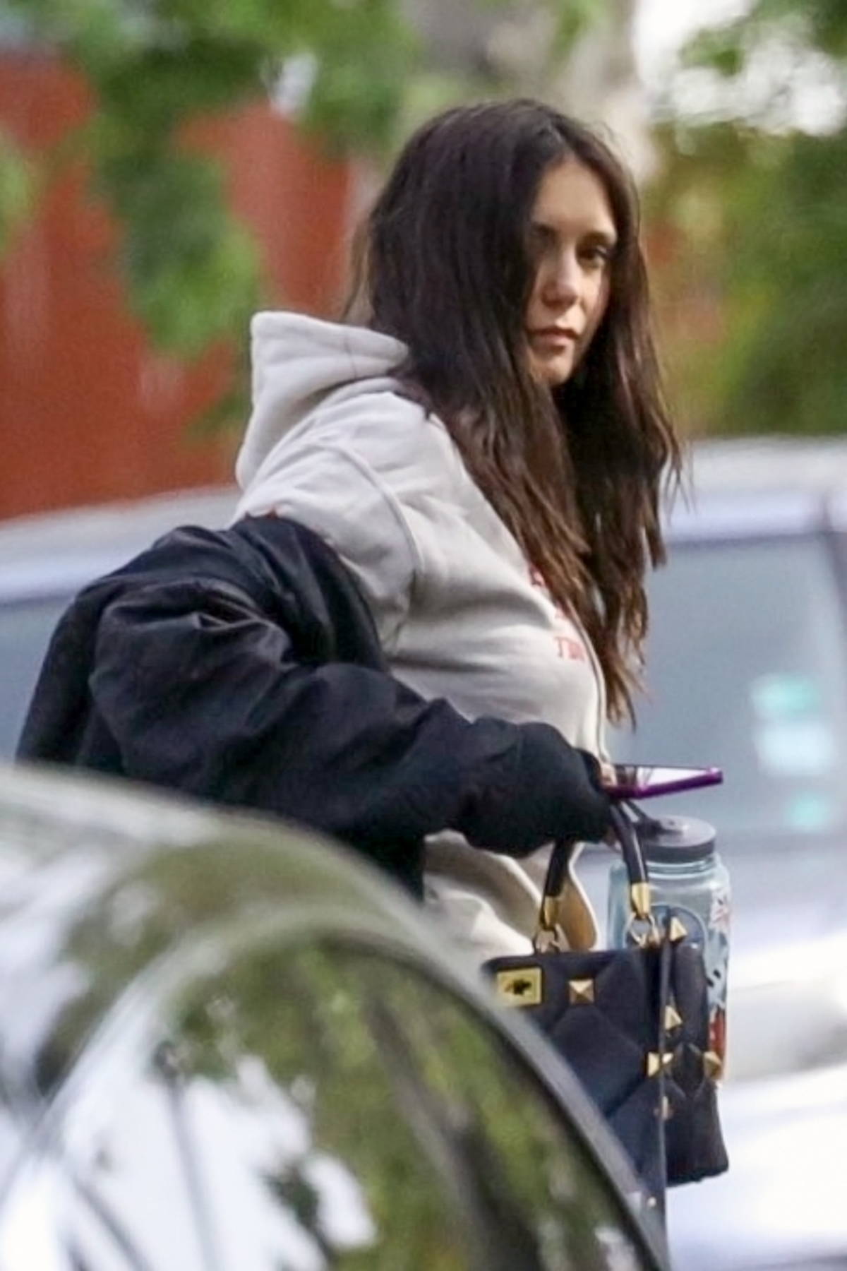 Nina Dobrev sports a cropped hoodie and leggings as she leaves after a  workout session in