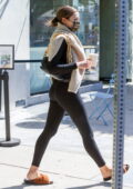 April Love Geary shows off her curves in a form-fitting jacket and leggings  while making