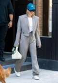 Hailey Bieber rocks a grey pinstriped suit and sneakers as she leaves her apartment in Brooklyn, New York