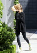 Hailey Bieber sports an oversized black sweater and leggings while visiting  Scooter Braun's office in Beverly Hills, California