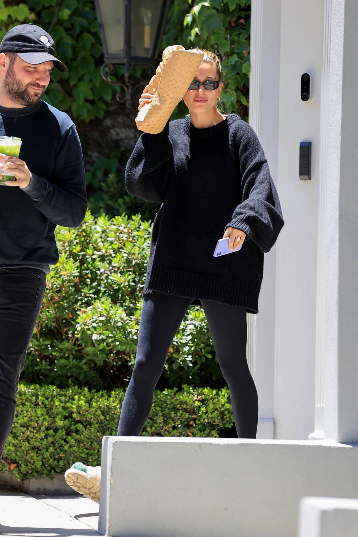 Hailey Bieber sports an oversized black sweater and leggings while