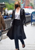 Karlie Kloss looks stylish in a leather trench coat, a white shirt and black trousers while out for stroll in New York City