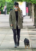 Lili Reinhart dons a houndstooth coat while walking her dog in Vancouver, California
