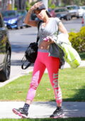 sofia boutella flashes her abs in bright pink nike leggings as she