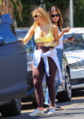 Addison Rae sports a yellow sports bra and brown leggings for a workout  session in West Hollywood, California