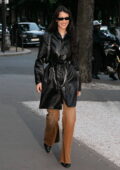 Bella Hadid rocks a leather trench coat and tan denim pants while stepping out in Paris, France