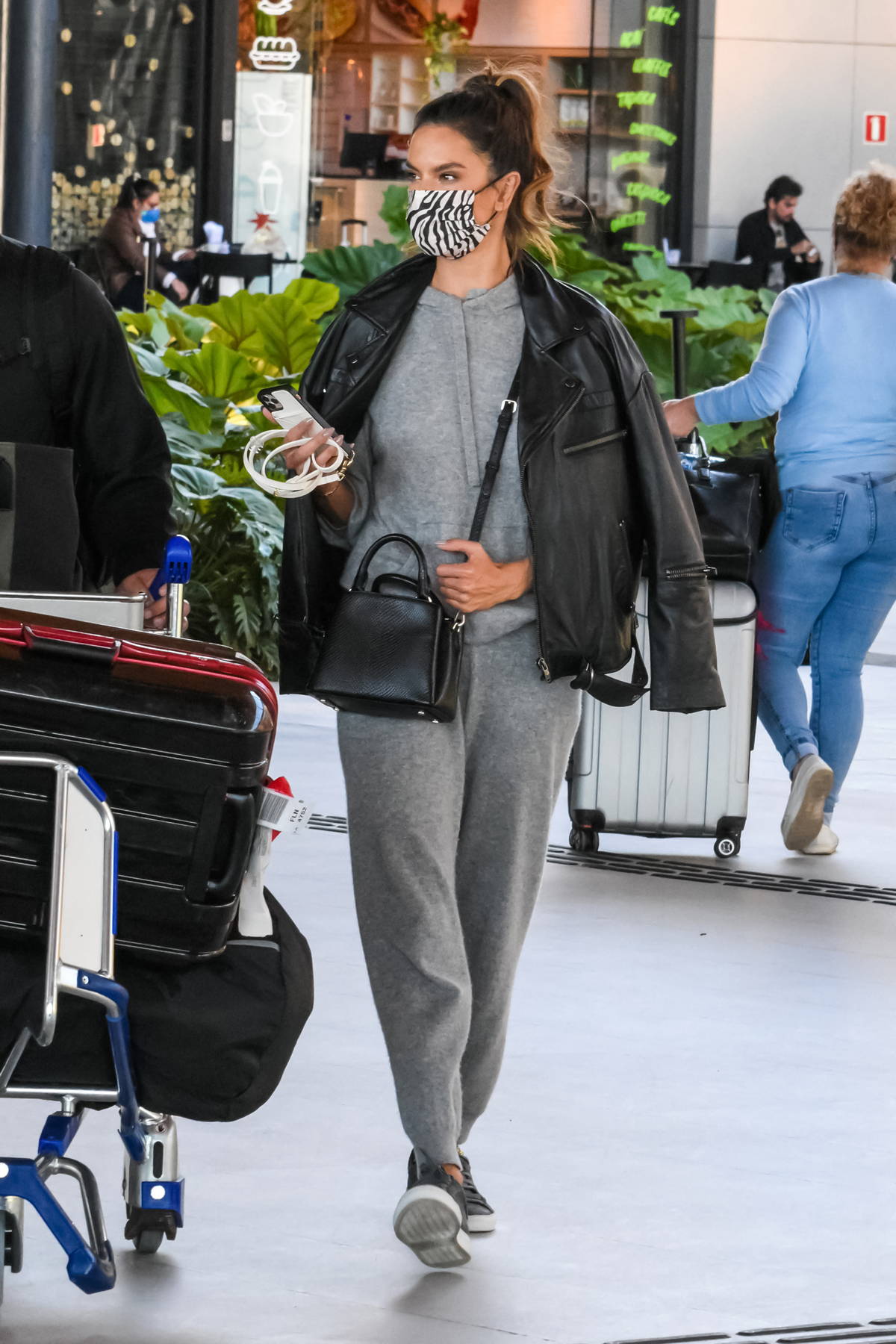 Alessandra Ambrosio wears casual denim overalls at LAX