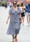 Kelly Brook is all smiles as she leaves Heart Radio wearing a gingham dress in London, UK