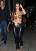 Kim Kardashian flaunts her perfectly toned midriff in a crop top