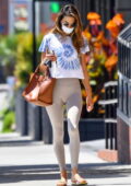 Alessandra Ambrosio looks fit as ever in beige leggings and tie