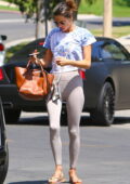 Alessandra Ambrosio looks fit as ever in beige leggings and tie