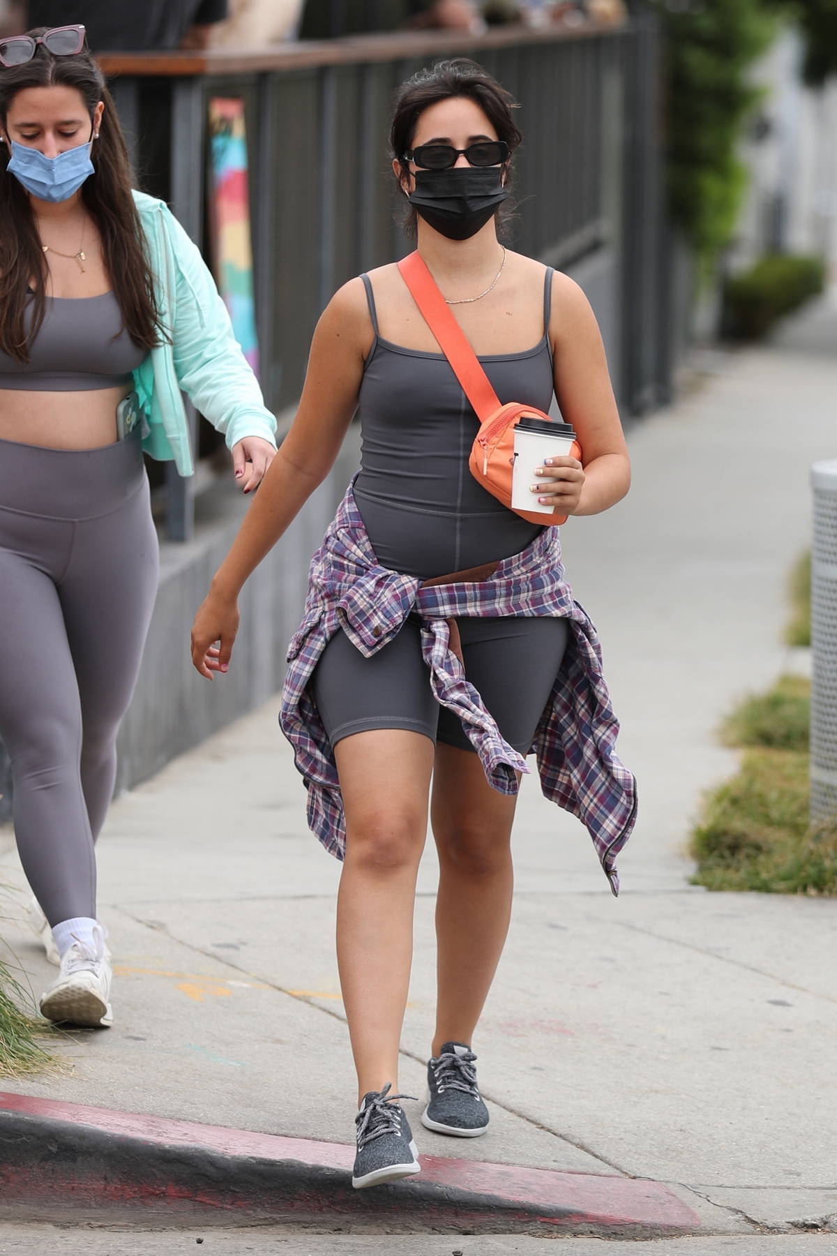 Camila Cabello steps out for coffee wearing a black t-shirt and legging  shorts in West