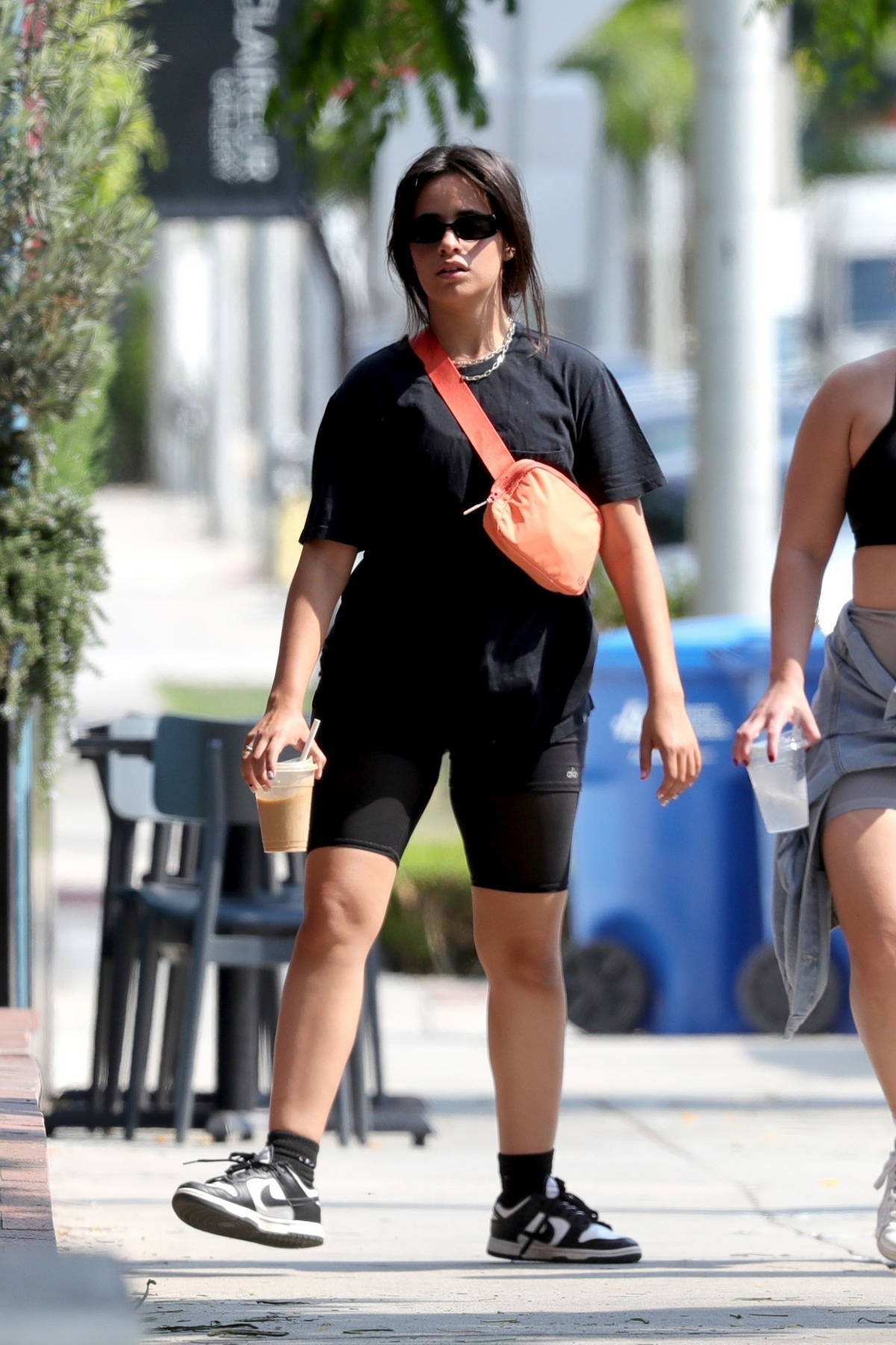 https://www.celebsfirst.com/wp-content/uploads/2021/08/camila-cabello-steps-out-for-coffee-wearing-a-black-t-shirt-and-legging-shorts-in-west-hollywood-california-190821_7.jpg