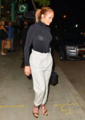 Jennifer Lopez looks great in a black skin-tight turtleneck and cream trousers during a night out in Los Angeles