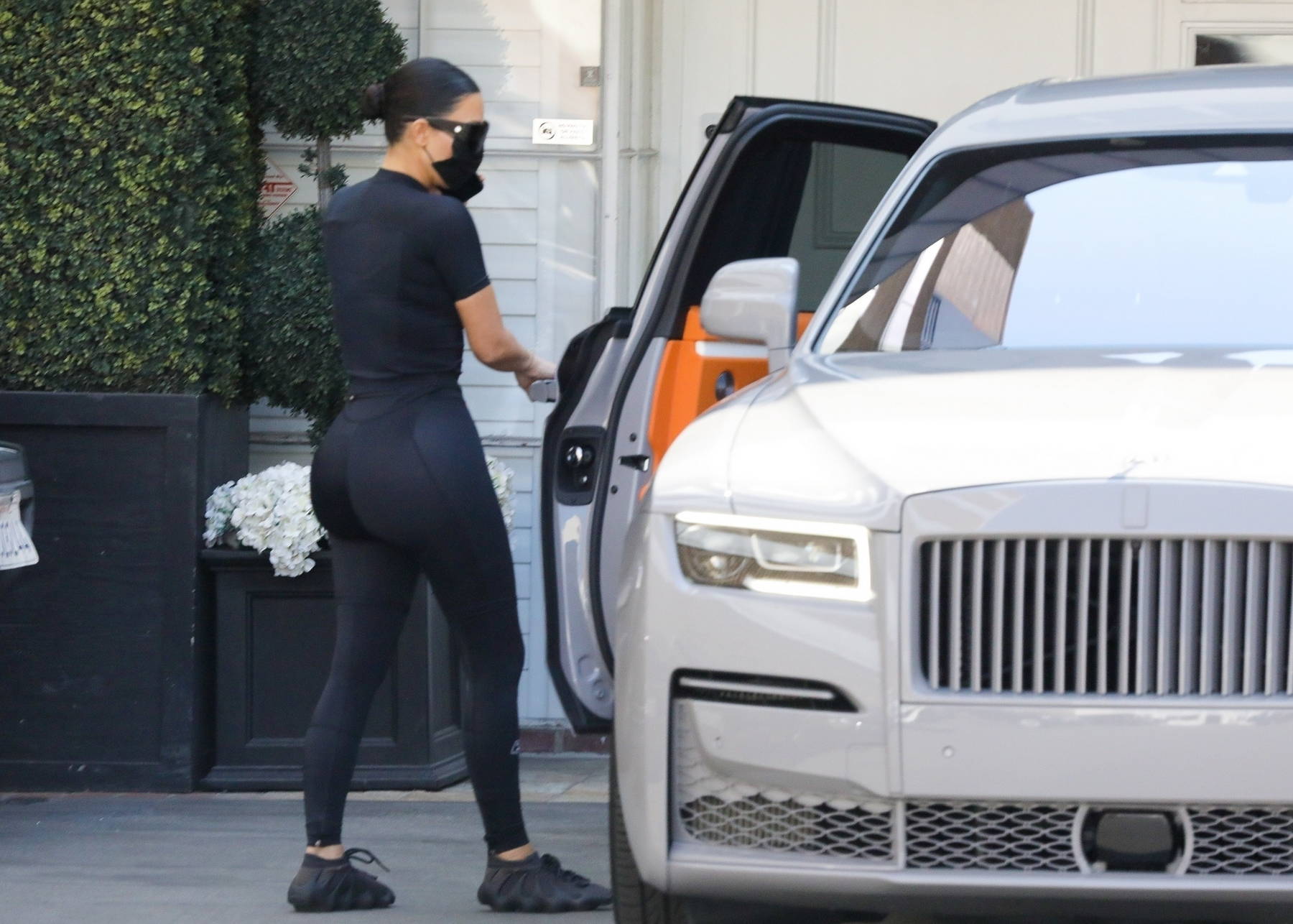 Kim Kardashian flaunts her curves in form-fitting black top and
