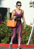 Lucy Hale displays her taut physique in a set of purple sports bra and leggings while leaving a yoga class in Los Angeles