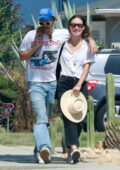 Olivia Wilde and Harry Styles wrap their arms around each other while enjoying a walk after lunch in Los Feliz, California