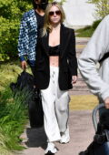 Sydney Sweeney pairs a crop top with a black blazer as she flashes her midriff while leaving her hotel in Venice, Italy