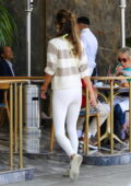 Alessandra Ambrosio looks fab in a striped sweater and white leggings while  out for lunch in