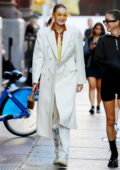 Gigi Hadid looks chic in a white coat while stepping out for a stroll in New York City