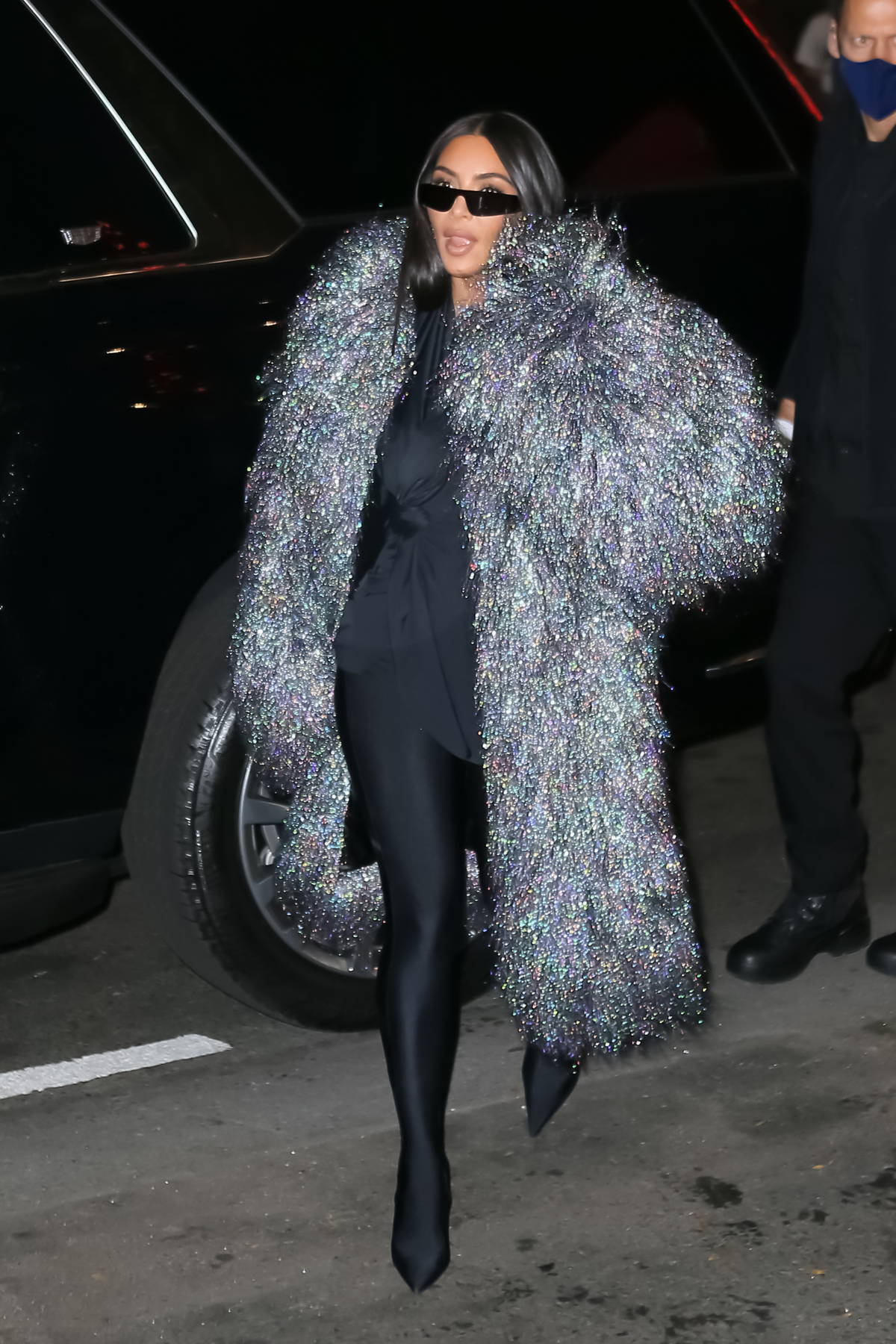 kim kardashian dazzles in a metallic fur coat over her all-black ...