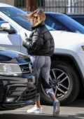 Hailey Bieber shows off her toned physique in a black sports bra and  leggings as she