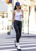 Shanina Shaik rocks black leather pants with a white tank top and boots while stepping out in New York City