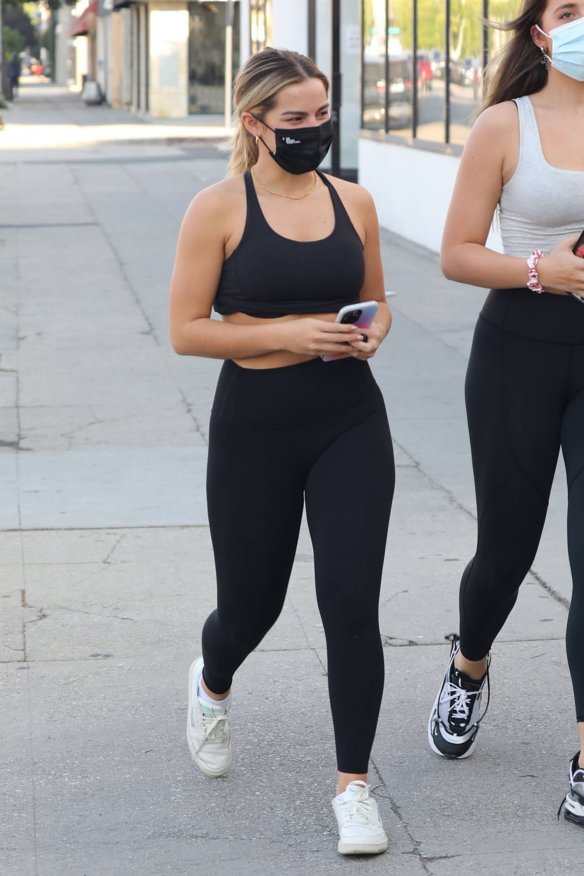 addison rae flaunts her curves in black leggings while grabbing a