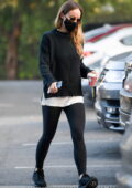 Olivia Wilde wears a black sweater and leggings on a Starbucks coffee run in Los Angeles