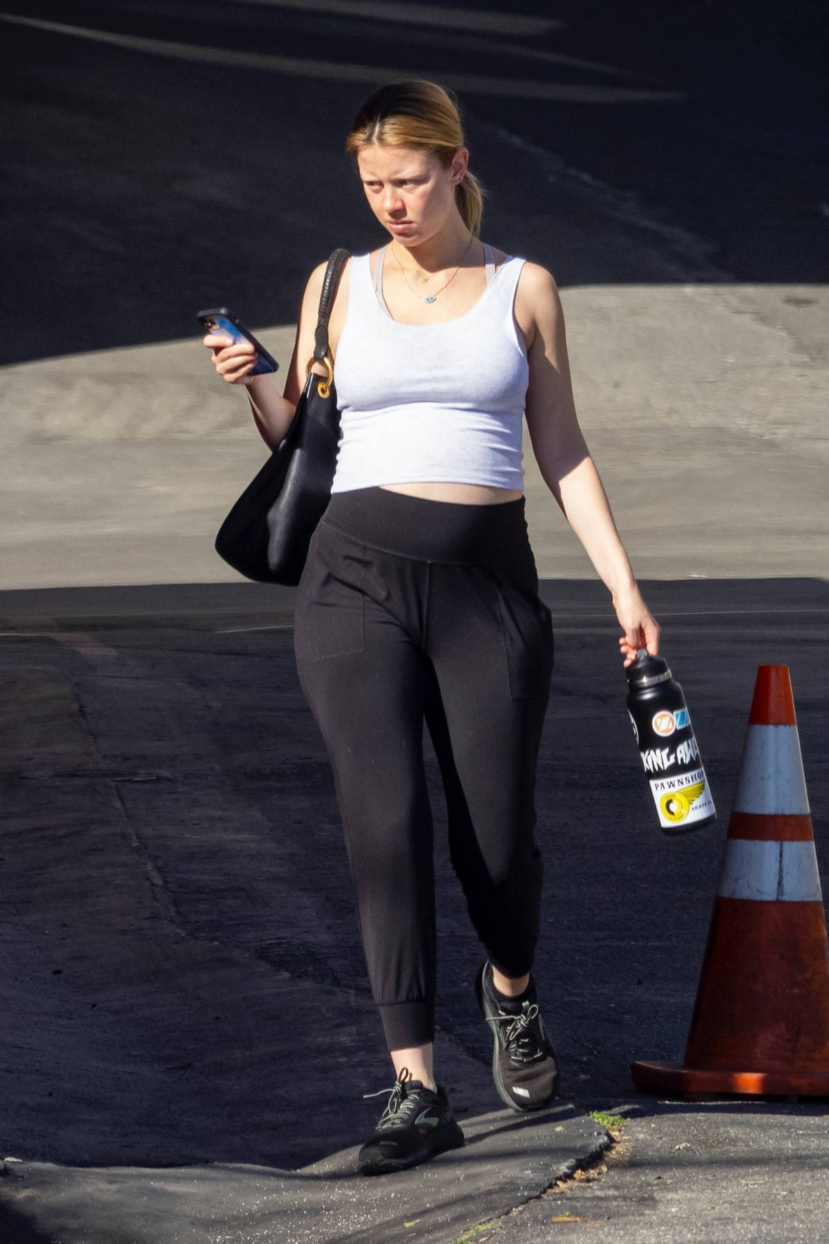 mia goth displays her growing baby bump in tank top and joggers